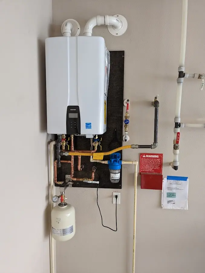 Professional plumber installing copper piping in a Spring home